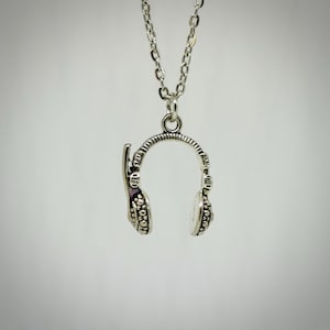 May include: A white ceramic mug with a black handle and the text "But First, Coffee" in a black, handwritten-style font. The mug is on a white surface.