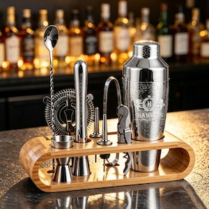 May include: A stainless steel cocktail shaker set with a wooden stand. The set includes a shaker engraved with the text HAWKINS, a twisted bar spoon, a strainer, a muddler, a jigger, a corkscrew, and pourers. All items are arranged in a bamboo holder.