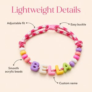 May include: A pink and white patterned cord necklace featuring smooth acrylic beads in various colors and a pink plastic buckle. The necklace includes the custom name BELLA spelled out in block letters, with text labels indicating an adjustable fit, easy buckle, smooth acrylic beads, and custom name.
