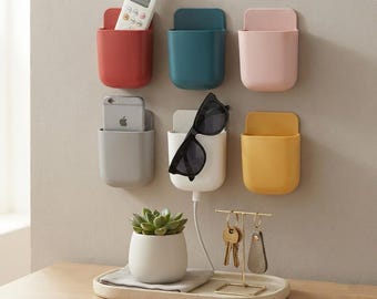 Wall Mount Phone Holder – Adhesive Storage Pocket for Remotes, Bedroom Living Room Decor item