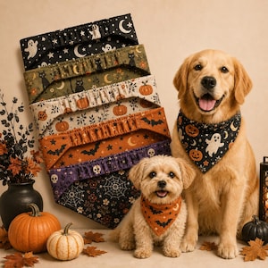 May include: A collection of triangular pet bandanas featuring Halloween patterns including ghosts, pumpkins, bats, skulls, and spiderwebs, displayed alongside a golden retriever and a small light-colored dog wearing matching bandanas.