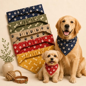 May include: A collection of five fabric pet bandanas featuring various patterns including paw prints and bones in navy, olive, beige, red, and yellow. A golden retriever and a small fluffy dog wear navy and red paw print bandanas respectively.