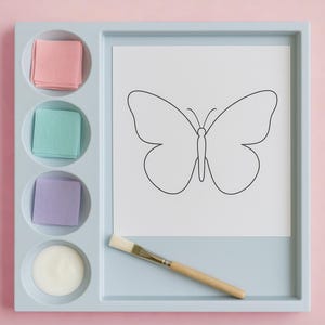 May include: A light blue rectangular craft tray featuring a square white paper with a black butterfly outline, a wooden paintbrush, and four circular compartments containing stacks of pink, teal, and purple paper squares and a white adhesive.