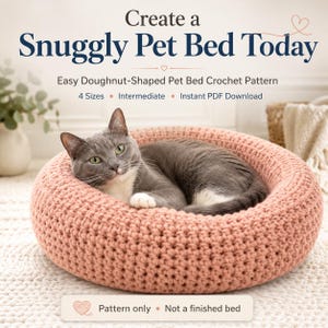 Könnte beinhalten: Eine graue Katze ruht in einem runden, pfirsichfarbenen gehäkelten Haustierbett. Der Text lautet: Create a Snuggly Pet Bed Today, Easy Doughnut-Shaped Pet Bed Crochet Pattern, 4 Sizes, Intermediate, Instant PDF Download, Pattern only, Not a finished bed.