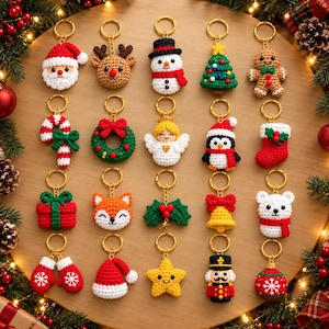 May include: A collection of twenty crocheted Christmas-themed keychains arranged in a grid. Designs include Santa, a reindeer, snowman, tree, gingerbread person, candy cane, wreath, angel, penguin, stocking, gift, fox, holly, bell, bear, mittens, hat, star, nutcracker, and ornament.