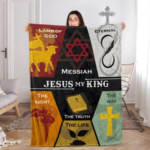 May include: A rectangular fleece blanket featuring a central black star with the text JESUS MY KING. Surrounding panels display a lamb, a Star of David, an infinity symbol, a torch, a Bible, a cross, and a sprout with text including LAMB OF GOD, ETERNAL, THE LIGHT, THE TRUTH, THE LIFE, and THE WAY.