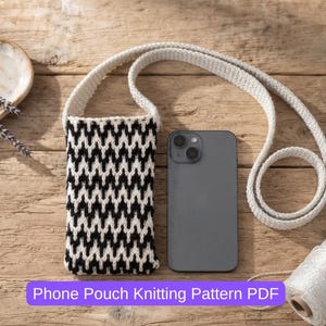 May include: A rectangular phone pouch featuring a black and white chevron knit pattern with a long matching strap, positioned next to a dark gray smartphone and a spool of white yarn. The text Phone Pouch Knitting Pattern PDF is visible.