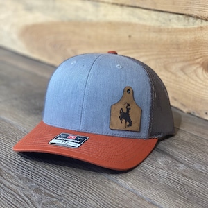 Wyoming Cowboy Leather Cow Tag Patch Orange Snapback Hat