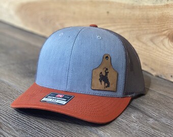 Wyoming Cowboy Leather Cow Tag Patch Orange Snapback Hat