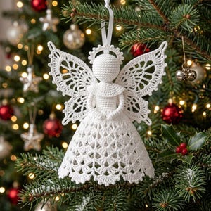 May include: A white crocheted angel ornament featuring a round head with a halo, intricate lace-like wings, and a bell-shaped dress with a scalloped hem. The figure is suspended by a white ribbon loop for hanging on a tree branch.