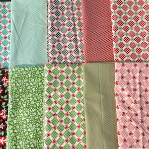 May include: A selection of fabric swatches featuring a variety of patterns and colours. The fabrics display floral, geometric, and dotted designs in red, green, pink, blue, and grey. The fabrics are arranged next to each other.