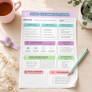 May include: A printed ADHD cleaning planner sheet with a light purple header, featuring sections for morning focus, midday check-in, evening wind-down, task breakdown, visual progress tracker, quick boost ideas, notes, reminders, and kind reminders.