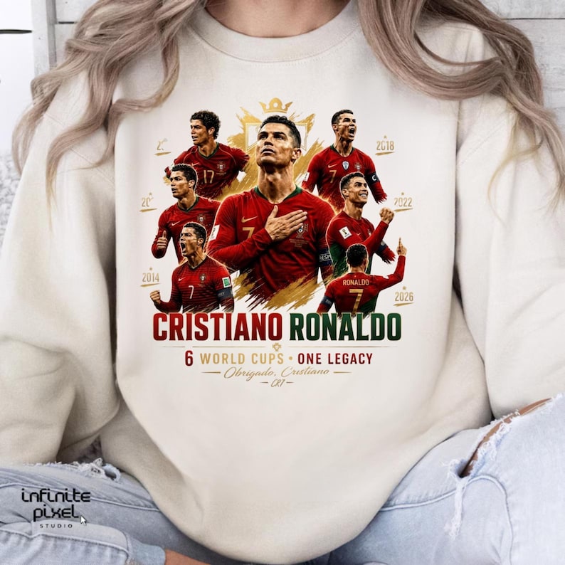 May include: A cream-colored crewneck sweatshirt featuring a graphic print of Cristiano Ronaldo in various poses wearing a red Portugal soccer jersey. The text reads CRISTIANO RONALDO, 6 WORLD CUPS - ONE LEGACY, and Obrigado, Cristiano - CR7.