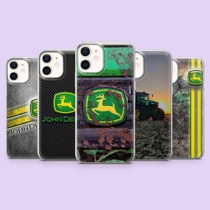 May include: Five smartphone cases featuring John Deere branding. Designs include a weathered metal texture, a black carbon fiber pattern, a muddy tractor grille, a tractor in a field at sunset, and a vertical yellow stripe with a deer logo.