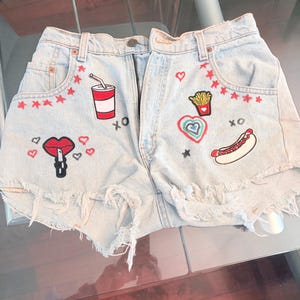 Women's denim shorts with original art work and patches