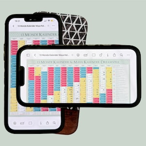 May include: Two smartphones displaying a digital 13 Monde Kalender & Maya Kalender Dreamspell chart. The screens show a grid of pink, blue, and yellow color-coded squares with small icons. One phone is vertical, and the other is positioned horizontally.