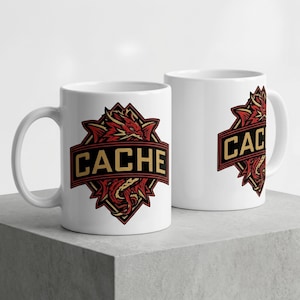 May include: Two white ceramic mugs featuring a graphic design of a red dragon coiled behind a black and gold banner with the text CACHE in bold capital letters. The dragon has sharp features and the design is centered on the front of each mug.
