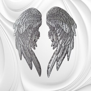May include: A pair of embroidered patches featuring detailed silver-gray angel wings. Each wing displays intricate feather textures with layered plumage, rendered in a metallic thread finish that creates a realistic, dimensional appearance.