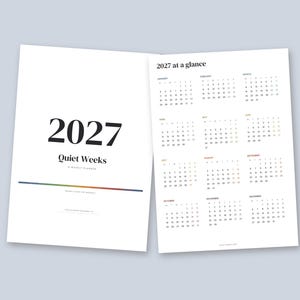 May include: A 2027 Quiet Weeks weekly planner with a white cover featuring the year in large black text and a colorful horizontal line. The open page displays a 2027 at a glance calendar with all twelve months organized in a grid.