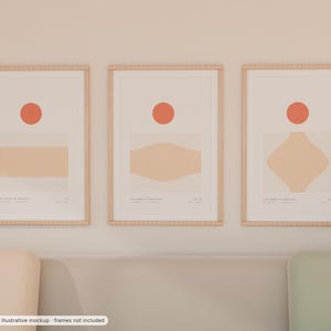 May include: Three vertical wall art prints in light wood frames, each featuring a solid orange circle above a beige geometric shape with fine vertical lines. The prints include small text at the bottom, displaying the titles and coordinates.