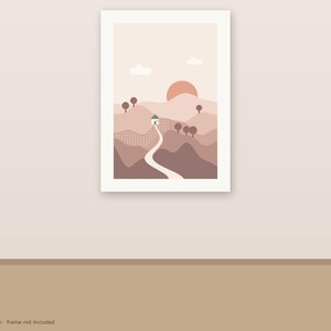 May include: A vertical wall art print featuring a landscape illustration with layered hills in shades of brown and beige. A winding path leads to a small house, with a large sun, two clouds, and stylized trees set against a light background.