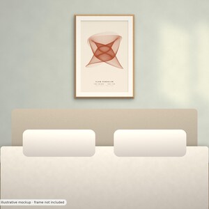 May include: A framed wall art print featuring a geometric, rust-colored abstract line pattern on a cream background. The text SLOW PENDULUM, 100 SERIES, 008 1/50 is printed in black at the bottom center of the artwork within a light wood frame.