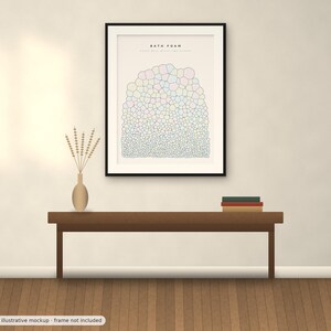 May include: A framed wall art print titled BATH FOAM featuring a graphic illustration of multicolored bubbles in varying sizes arranged in a rounded cluster, displayed in a black frame hanging above a wooden bench with a vase and books.