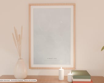 May include: A vertical rectangular wall art print in a light wood frame featuring a pale grey background with thin white abstract line patterns. The text FIRST ICE is printed in black at the bottom centre of the print.