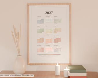 May include: A 2027 wall calendar print featuring a dot-grid layout for each month in a gradient of muted colours. The calendar is displayed in a light wood frame and includes the text 2027 at the top with month names listed below.