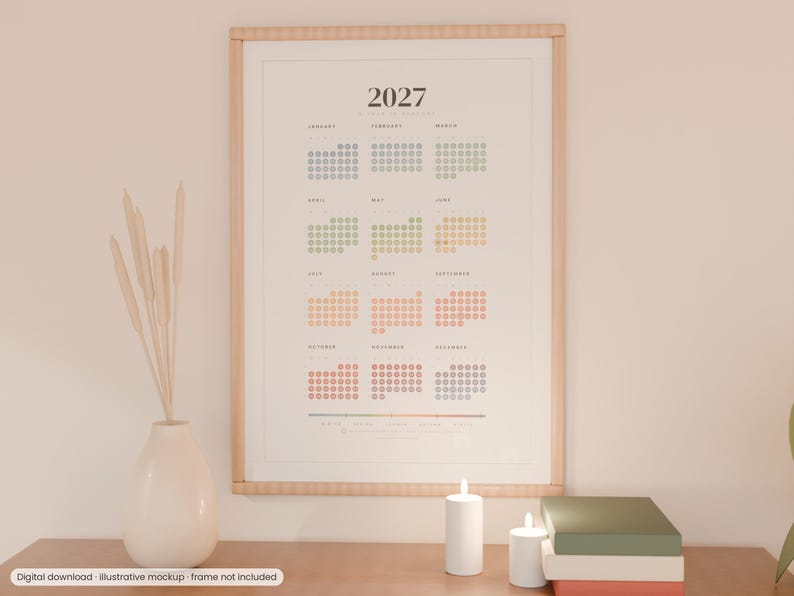 May include: A 2027 wall calendar print featuring a dot-grid layout for each month in a gradient of muted colors. The calendar is displayed in a light wood frame and includes the text 2027 at the top with month names listed below.