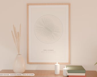 May include: A framed wall art print featuring a minimalist graphic of two overlapping circular ripple patterns. The text "TWO STONES" is printed in black below the graphic. The print is enclosed in a light-coloured wooden frame.