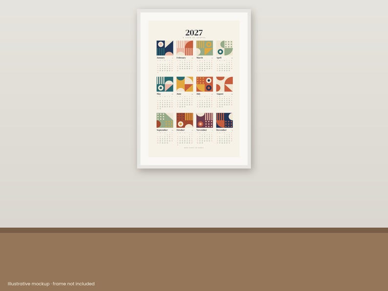 May include: A 2027 wall calendar print featuring twelve monthly grids, each topped with a unique geometric square design in shades of blue, red, yellow, and green on a cream background, displayed within a white frame on a wall.