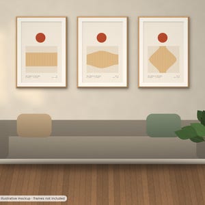 May include: A set of three framed wall art prints featuring abstract geometric shapes in tan and orange on a cream background. Each print displays a solid orange circle above a tan form with varying contours and small text at the bottom.