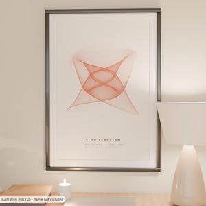 May include: A framed wall art print featuring a geometric orange line art design centered on a light background. The text SLOW PENDULUM and TWO SWINGS ONE LINE is printed in black below the graphic. The frame is dark gray with a thin profile.