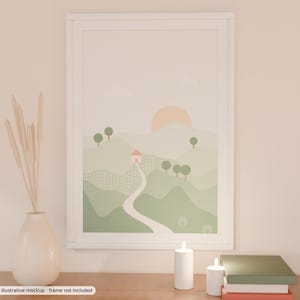 May include: A framed wall art print featuring a landscape illustration of rolling green hills, a winding path, a small house with a pink roof, and a pale orange sun. The artwork is displayed in a white frame on a surface with a vase of dried reeds.