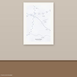 May include: A white rectangular poster featuring various animal footprints in light gray, labeled with text including "Tracks in Snow" at the bottom. The print displays multiple paths of tracks crossing the page, with small text identifiers next to each distinct set of markings.