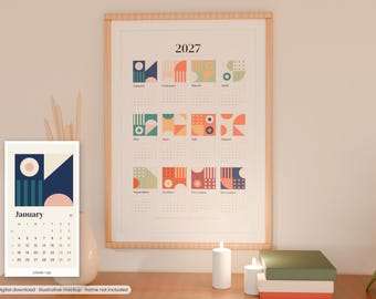 May include: A 2027 wall calendar featuring twelve monthly sections, each with a unique geometric graphic in shades of blue, orange, green, and pink. The calendar displays the year 2027 at the top, with months listed from January to December.