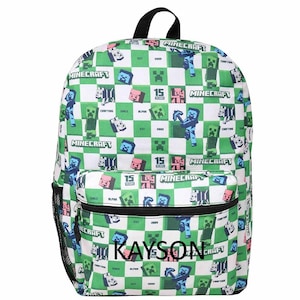 May include: A green and white checkered backpack featuring a Minecraft pattern with various game characters, the text Minecraft, and the name Kayson printed on the front pocket. The bag includes a black top handle and a black mesh side pocket.