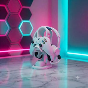 May include: A white gaming controller and white over-ear headphones resting on a white, curved, multi-tiered display stand. The controller features black analog sticks and a multi-colored button layout, while the headphones have black ear cushions.