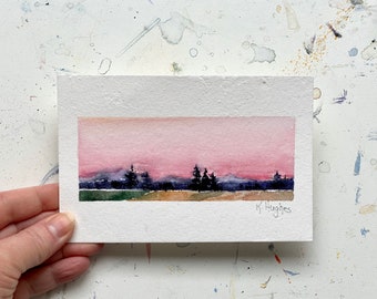 Pink Sunset original small pink brilliant sky painting on watercolor paper, green grassy meadow, pink setting sun painting.