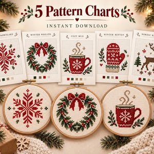 May include: Five cross-stitch pattern charts featuring a Nordic snowflake, winter wreath, cozy mug, winter mitten, and Nordic reindeer. Below the charts are three wooden embroidery hoops displaying the snowflake, wreath, and mug designs.