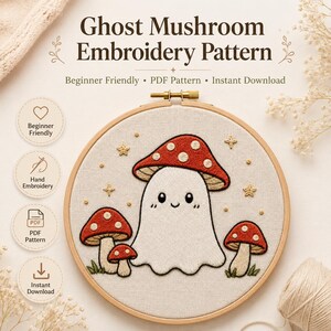 Könnte beinhalten: Ein runder Holzstickrahmen mit einem handgestickten Motiv eines weißen, pilzförmigen Geistes mit rotem Hut, umgeben von kleineren roten Pilzen und goldenen Sternen. Der Text auf dem Bild lautet Ghost Mushroom Embroidery Pattern.