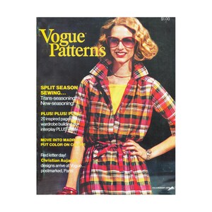 May include: A vintage Vogue Patterns magazine cover from July/August 1975. The cover features a woman wearing a red, yellow, and black plaid shirt and sunglasses. The magazine title is in yellow, with text about sewing and fashion.