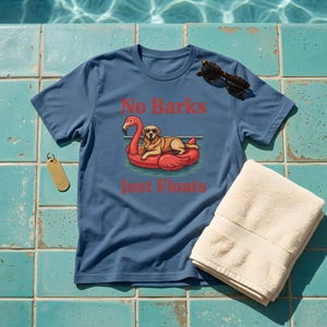May include: A blue short-sleeved t-shirt featuring a graphic of a golden retriever wearing sunglasses while relaxing on a pink flamingo pool float. The text "No Barks" appears above the dog and "Just Floats" appears below in red lettering.