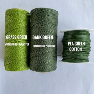 May include: Three spools of thread in varying shades of green. The left spool is grass green waterproof polyester, the middle spool is dark green waterproof polyester, and the right spool is pea green cotton.