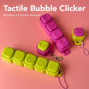 May include: Tactile Bubble Clicker Keychain 8 Tactile Textures. A collection of bright pink and lime green square sensory fidget devices with various raised patterns including stripes, dots, circles, and hexagons, each featuring a small metal ball chain.
