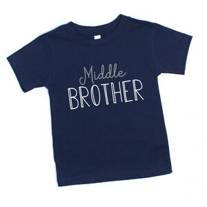 May include: A navy blue t-shirt with the text "Middle Brother" in white.