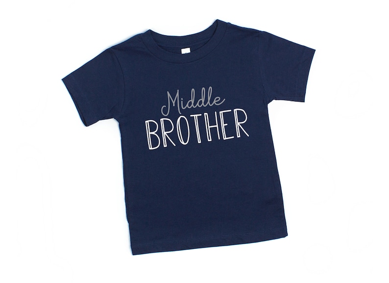 May include: A navy blue t-shirt with the text "Middle Brother" in white.