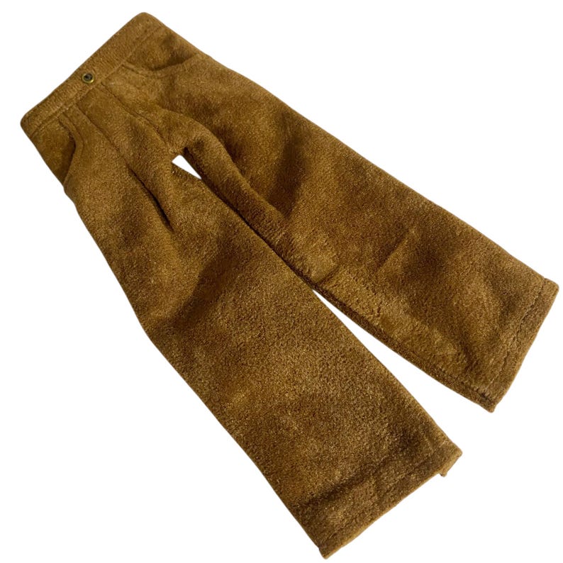 May include: A pair of brown trousers featuring a textured, fuzzy fabric finish. The pants include a waistband with a single visible metal button closure, two front pockets, and a straight-leg cut that extends down to the hemline.