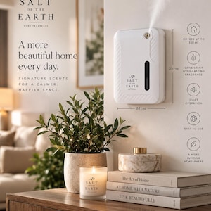 May include: A white wall-mounted fragrance diffuser measuring 20 cm by 14 cm, emitting a fine mist. The device features the Salt of the Earth logo, a vertical viewing window, and textured side panels. Text includes A more beautiful home every day.